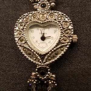 Bracelet watch with heart shaped watch face.